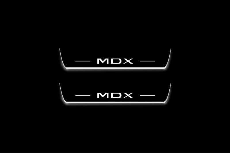 Two short door sill plates with MDX lettering and edges illuminated in white, straight-on view on a dark background.