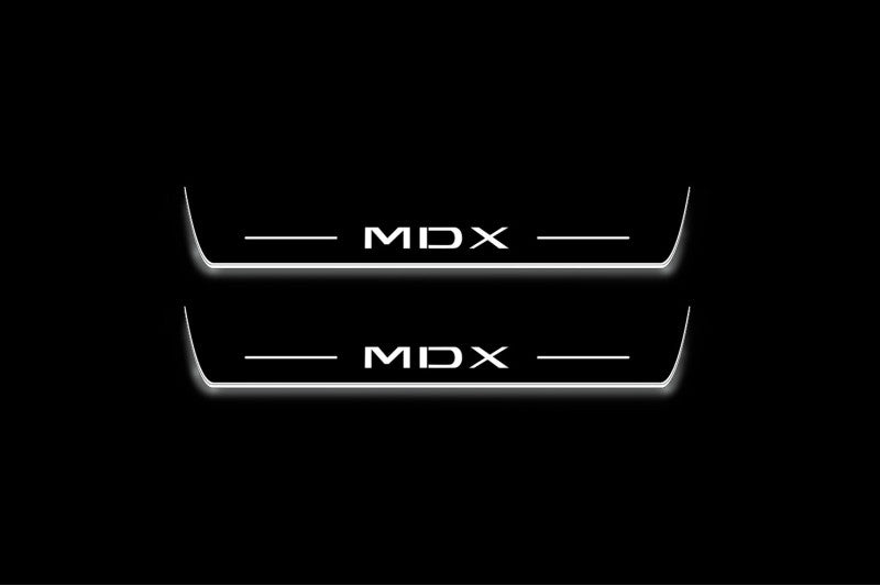 Two long door sill plates with MDX lettering and edges illuminated in white, straight-on view on a dark background.