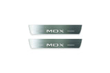 Two short silver-finished door sill plates with MDX lettering on a light background, straight-on view.