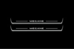 Two long door sill plates with Megane lettering and edges illuminated in white, straight-on view on a dark background.