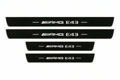 Catalogue illustration of two front and two rear black Matte PRO LED door sill plates with illuminated AMG E43 lettering for Mercedes-Benz E-Class Estate S213; final dimensions are selected during manufacture.