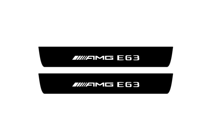 Catalog illustration of two black front door sill plates with AMG E63 lettering.