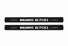 Catalogue illustration showing two FRONT black Matte PRO LED door sill plates with white Brabus G700 lettering for Mercedes-Benz G-Class W463; FRONT+REAR is available but rear plates are not pictured; dimensions are selected during manufacture.