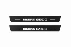 Catalogue illustration showing two FRONT black Matte PRO LED door sill plates with white Brabus G900 lettering for Mercedes-Benz G-Class W463; FRONT+REAR is available but rear plates are not pictured; dimensions are selected during manufacture.