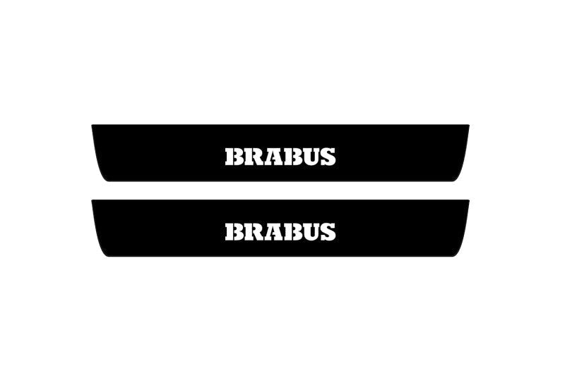 Catalog illustration of two black front door sill plates with Brabus lettering.