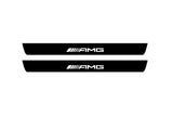 Catalog illustration of two black front door sill plates with AMG lettering.
