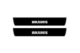 Catalog illustration of two black front door sill plates with Brabus lettering.