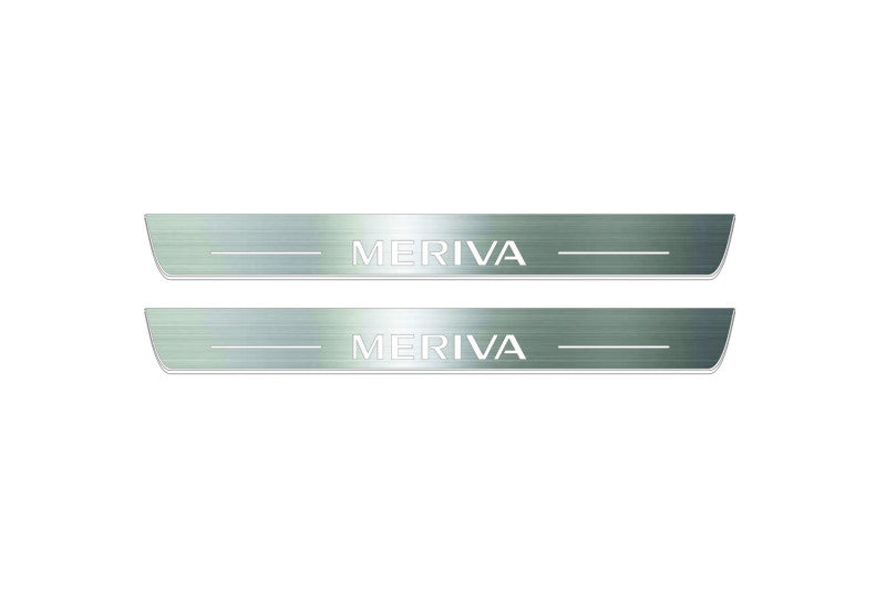 Two long silver-finished door sill plates with Meriva lettering on a light background, straight-on view.