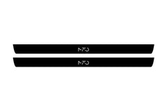 Catalog illustration of two black front door sill plates with MiTo lettering.