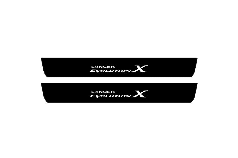 Catalog illustration of two black front door sill plates with Lancer Evolution X lettering.