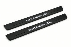 Catalogue illustration of two front black Matte PRO LED door sill plates with illuminated Outlander XL lettering for Mitsubishi Outlander; dimensions are selected during manufacture.