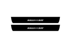 Catalog illustration of two black front door sill plates with Ralliart lettering.