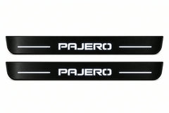 Catalogue illustration of two front black Matte PRO LED door sill plates with illuminated Pajero lettering for Mitsubishi Pajero Wagon V80; dimensions are selected during manufacture.