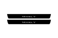 Catalog illustration of two black front door sill plates with Model Y lettering.