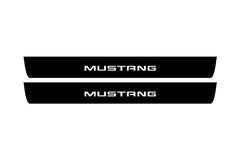 Catalog illustration of two black front door sill plates with Mustang lettering.