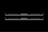 Two long door sill plates with Navara lettering and edges illuminated in white, straight-on view on a dark background.