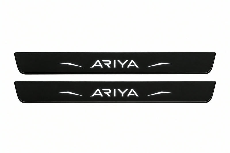 Catalogue illustration of two front black Matte PRO LED door sill plates with illuminated Ariya lettering for Nissan Ariya FE0; dimensions are selected during manufacture.