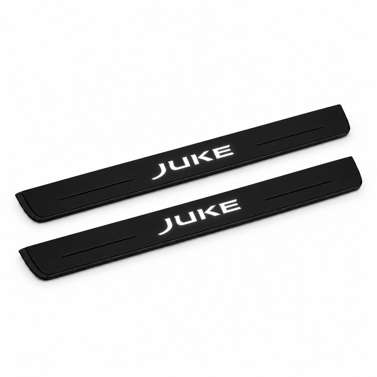 Catalogue illustration of two black Matte PRO front door sill plates with illuminated JUKE lettering on the top surface. Edges are unlit; rear plates for FRONT+REAR are not pictured. Final dimensions are selected for Nissan Juke F15 during manufacture.