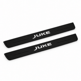 Catalogue illustration of two black Matte PRO front door sill plates with illuminated JUKE lettering on the top surface. Edges are unlit; rear plates for FRONT+REAR are not pictured. Final dimensions are selected for Nissan Juke F15 during manufacture.
