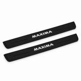 Catalogue illustration of two black Matte PRO front door sill plates with illuminated MAXIMA lettering on the top surface. Edges are unlit; rear plates for FRONT+REAR are not pictured. Final dimensions are selected for Nissan Maxima Sedan A36 during manufacture.