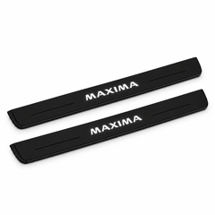 Catalogue illustration of two black Matte PRO front door sill plates with illuminated MAXIMA lettering on the top surface. Edges are unlit; rear plates for FRONT+REAR are not pictured. Final dimensions are selected for Nissan Maxima Sedan A36 during manufacture.