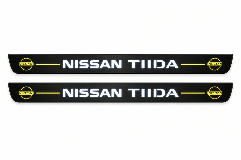 Catalogue illustration of two front black Matte PRO LED door sill plates with illuminated TIIDA lettering for Nissan Tiida C11; dimensions are selected during manufacture.
