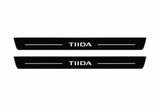 Catalogue illustration of two front black Matte PRO LED door sill plates with illuminated TIIDA lettering for Nissan Tiida I C11; dimensions are selected during manufacture.
