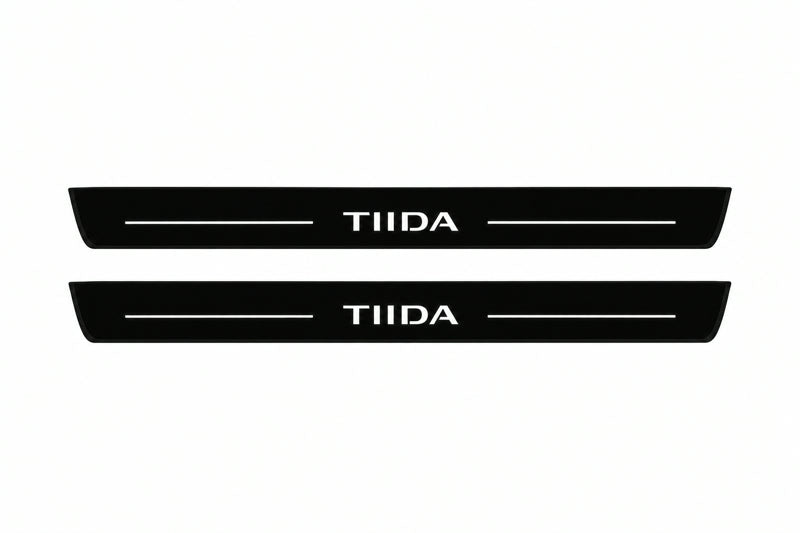 Catalogue illustration of two front black Matte PRO LED door sill plates with illuminated TIIDA lettering for Nissan Tiida I C11; dimensions are selected during manufacture.
