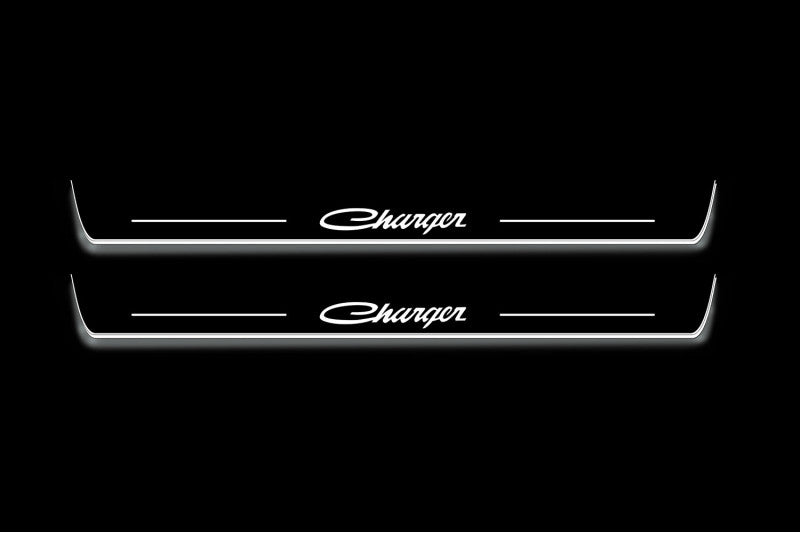 Two long door sill plates with Charger lettering and edges illuminated in white, straight-on view on a dark background.
