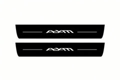 Catalogue illustration of two front black Matte PRO LED door sill plates with illuminated Adam lettering for Opel Adam M13; dimensions are selected during manufacture.