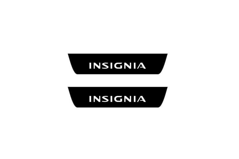 Catalog illustration of two black rear door sill plates with Insignia lettering.