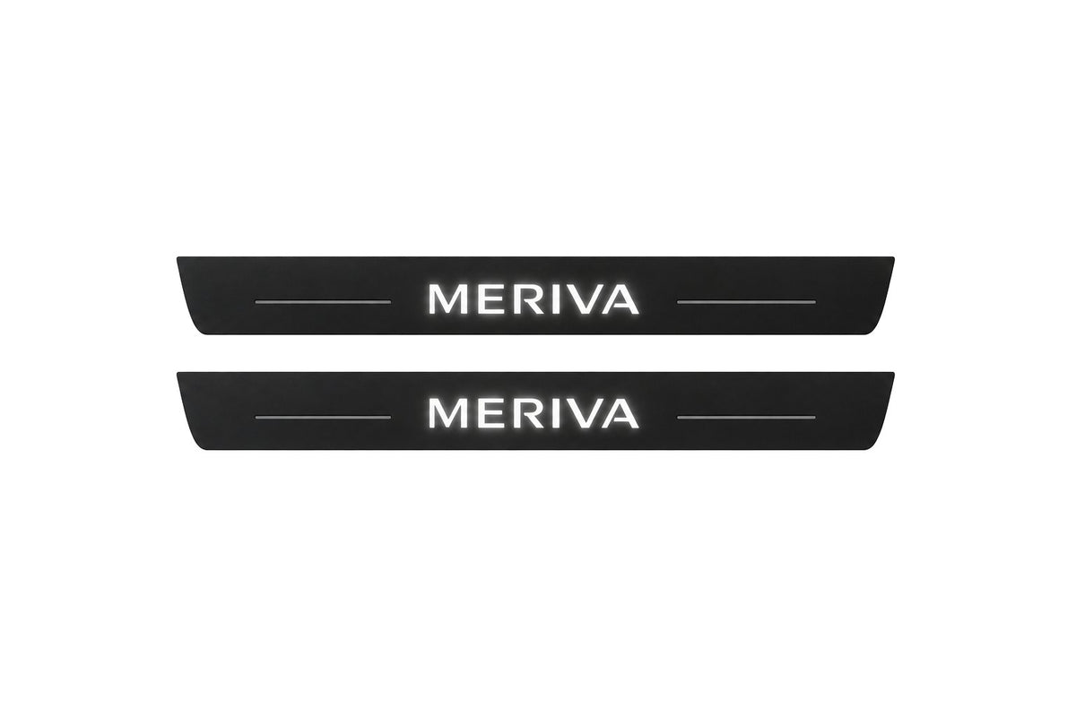 Catalogue illustration of two front black Matte PRO LED door sill plates with illuminated Meriva lettering for Opel Meriva A; dimensions are selected during manufacture.