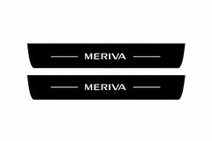 Catalogue illustration of two front black Matte PRO LED door sill plates with illuminated Meriva lettering for Opel Meriva A; dimensions are selected during manufacture.