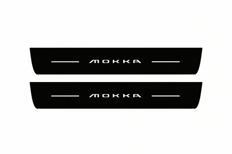 Catalogue illustration of two front black Matte PRO LED door sill plates with illuminated Mokka lettering for Opel Mokka II; dimensions are selected during manufacture.