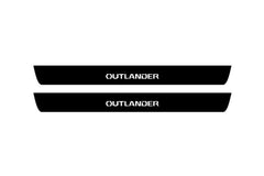 Catalog illustration of two black front door sill plates with Outlander lettering.