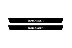 Catalog illustration of two black front door sill plates with Outlander lettering.