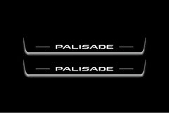 Two long door sill plates with Palisade lettering and edges illuminated in white, straight-on view on a dark background.