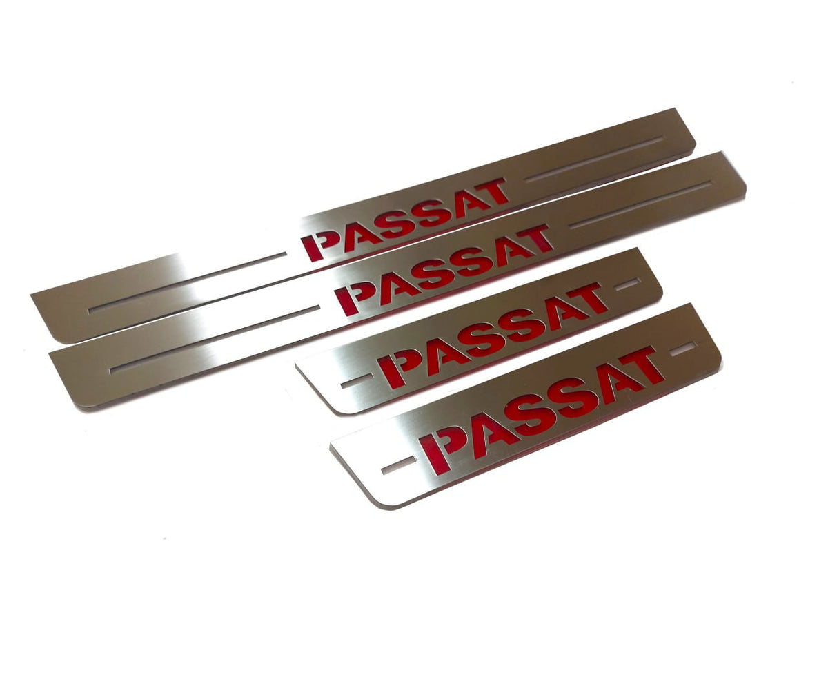Four silver-finished door sill plates with bold red Passat lettering, angled view.