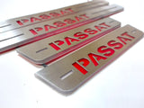 Close-up of bold red Passat lettering and horizontal slots on long and short silver-finished door sill plates.