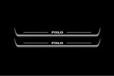 Two long door sill plates with Polo lettering and edges illuminated in white, straight-on view on a dark background.