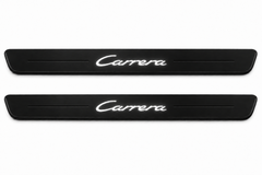 Catalogue illustration of two black Matte PRO front sill plates with illuminated cursive Carrera lettering on top. Side edges remain unlit; no rear plates or exact dimensions pictured.