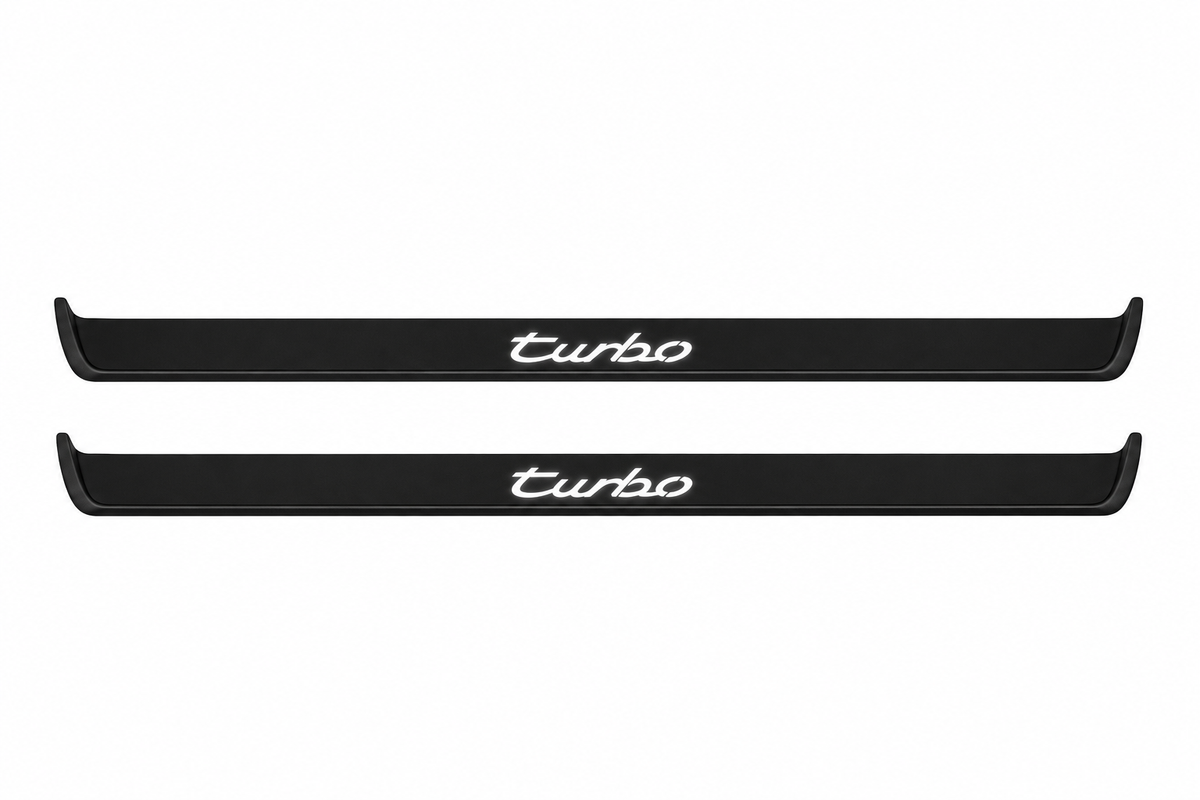 Catalogue illustration of two black Matte PRO front sill plates with illuminated cursive turbo lettering on top. Side edges remain unlit; no rear plates or exact dimensions pictured.