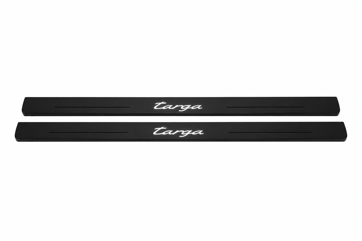 Catalogue illustration of two black Matte PRO front sill plates with illuminated cursive Targa lettering on top. Side edges remain unlit; no rear plates or exact dimensions pictured.