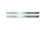 Two long silver-finished door sill plates with Primastar lettering on a light background, straight-on view.
