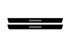 Catalog illustration of two black front door sill plates with Qashqai lettering.