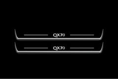 Two long door sill plates with QX70 lettering and edges illuminated in white, straight-on view on a dark background.