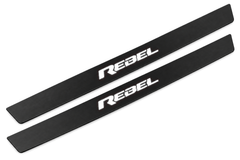 Matte PRO catalogue illustration showing two FRONT plates with illuminated REBEL lettering on a white background; Ram 1500 DT dimensions are selected during manufacture; rear plates are not pictured.