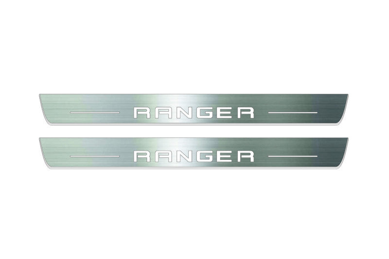 Two long silver-finished door sill plates with Ranger in block lettering lettering on a light background, straight-on view.