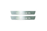 Two short silver-finished door sill plates with Ranger in block lettering lettering on a light background, straight-on view.