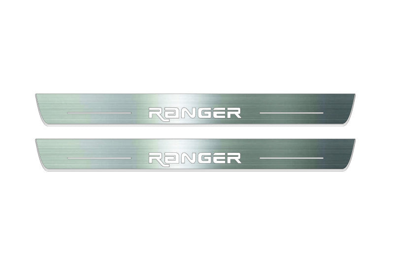 Two long silver-finished door sill plates with Ranger in angular lettering lettering on a light background, straight-on view.